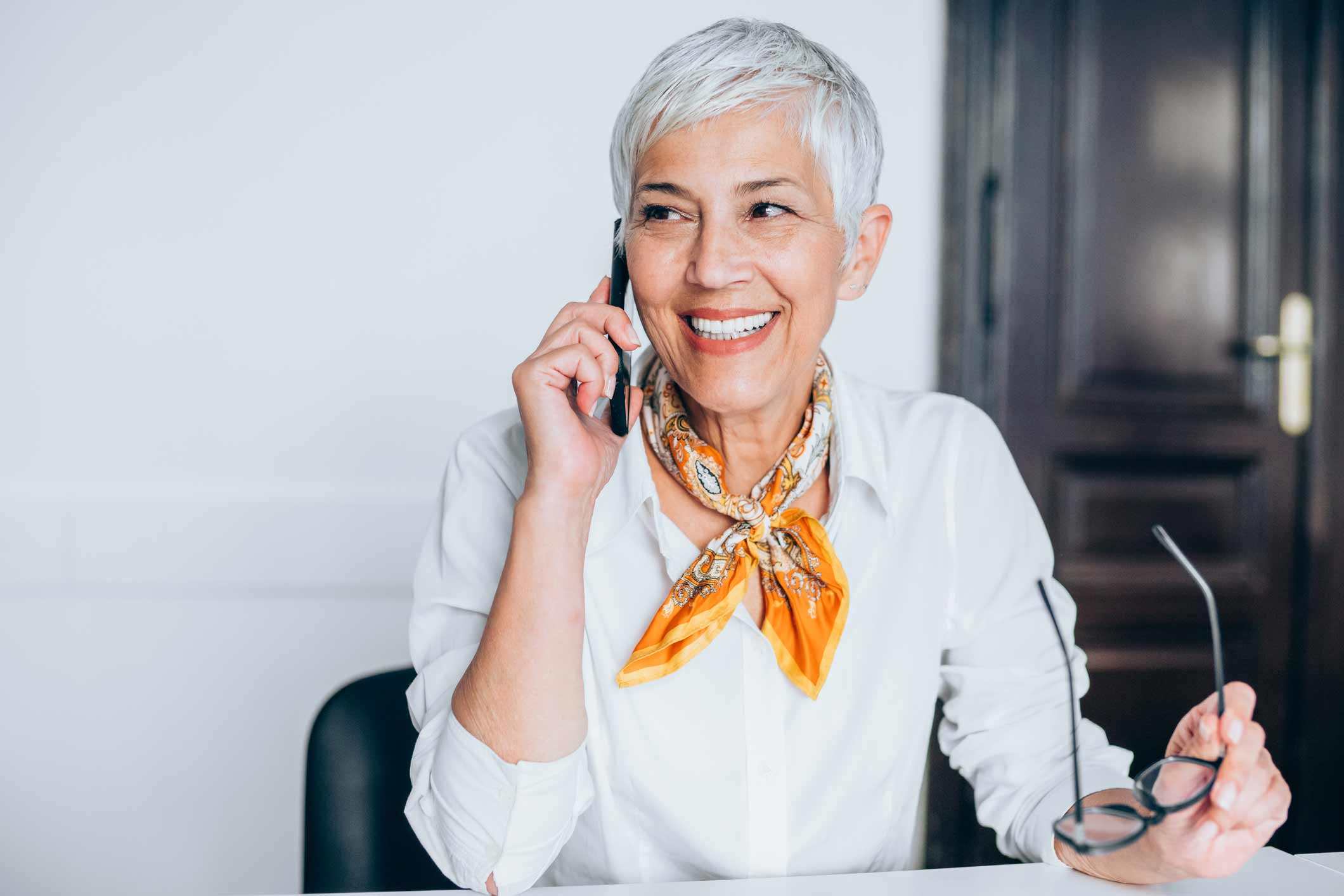 Woman contacting her audiologist on the phone