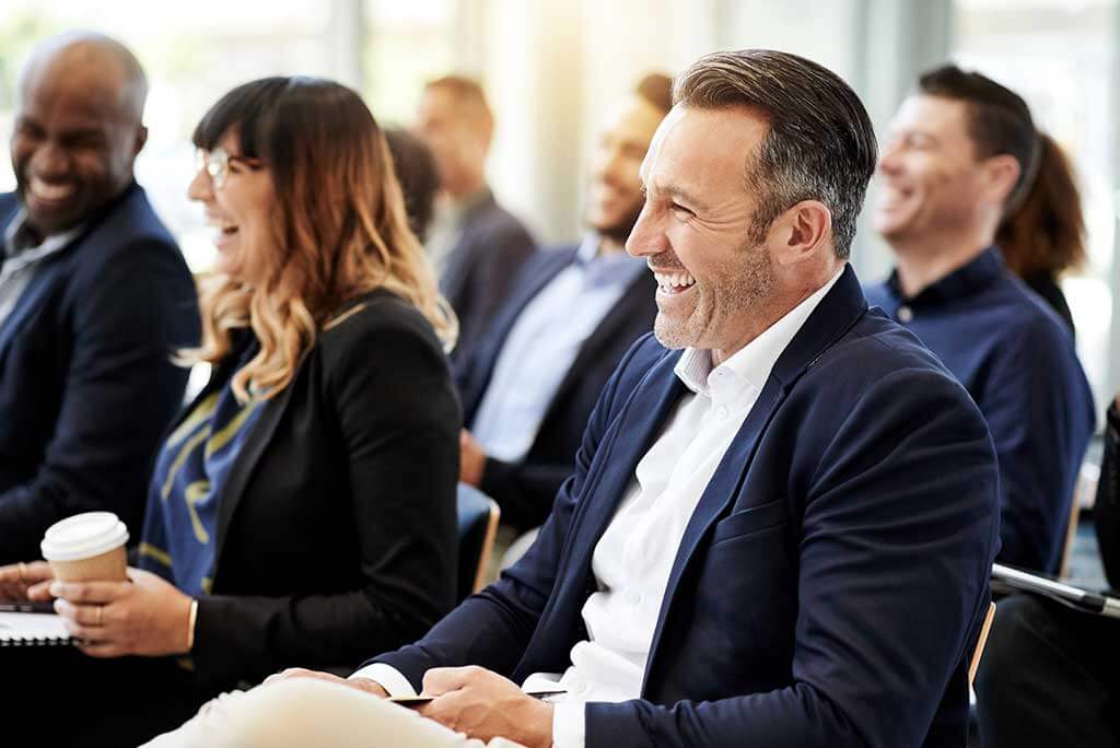 Business colleagues laughing at a conference